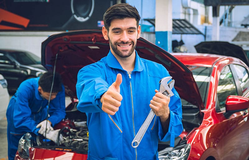 Mechanics holding wrench in the workshop garage.